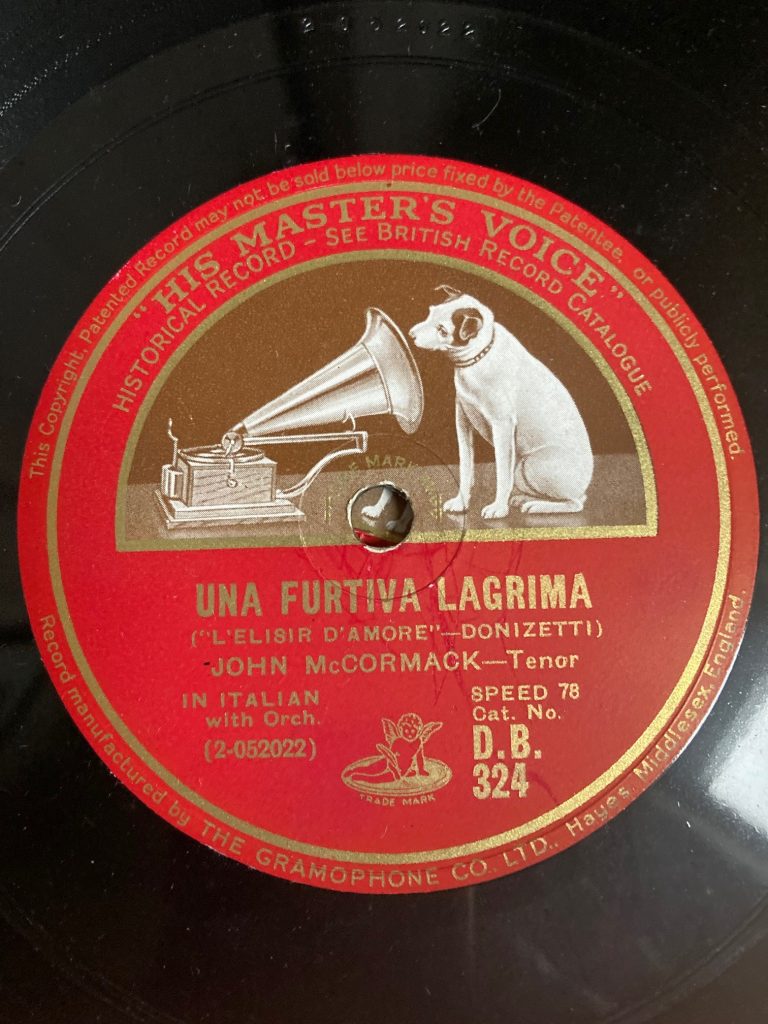 A close up photograph of a vinyl record. The record is: 'una furtiva lagrima(l'elisir d'amore - Donizetti)' with John McCormack, tenor, singing in Italian with orchestra.