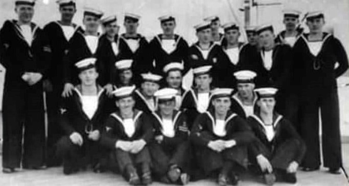 23 seamen are arranged for a photograph in three rows.